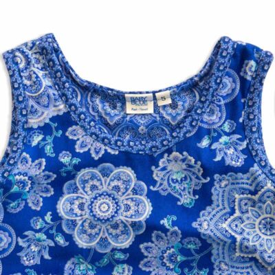 Close up view of the tank-top style top of a blue and silver flower shaped mandala printed fabric of a Baby Blue Mandala Twirling Dress by Cool Blue Maui size 5.